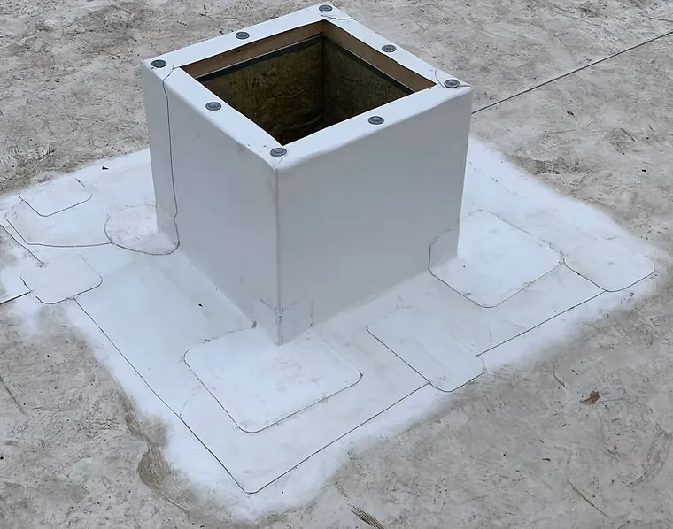 Curb and penetration flashing detail on a commercial roof